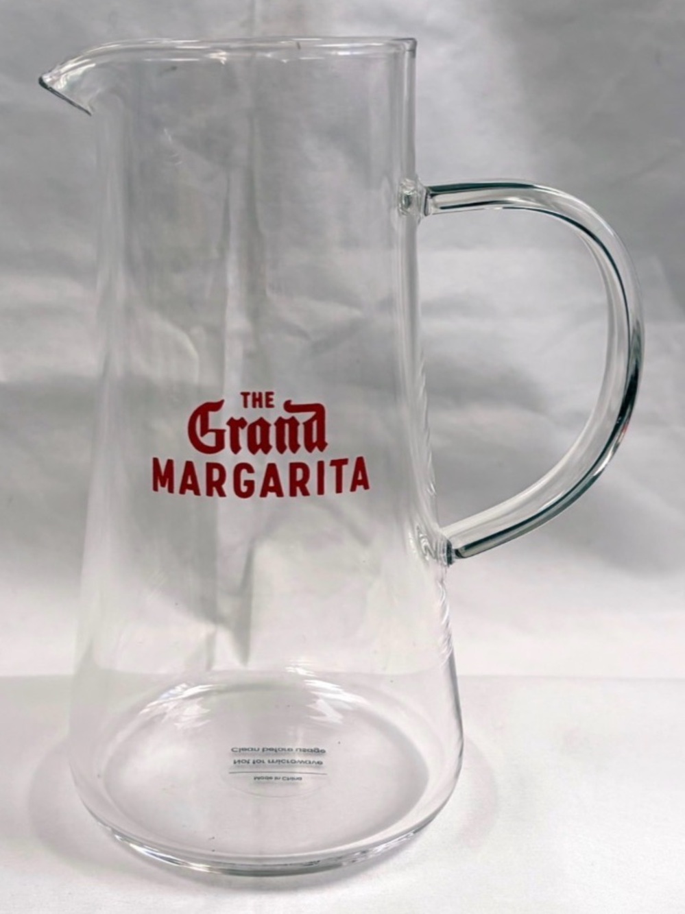 Clear Glass Pitcher with Red Logo The Grand Margarita.